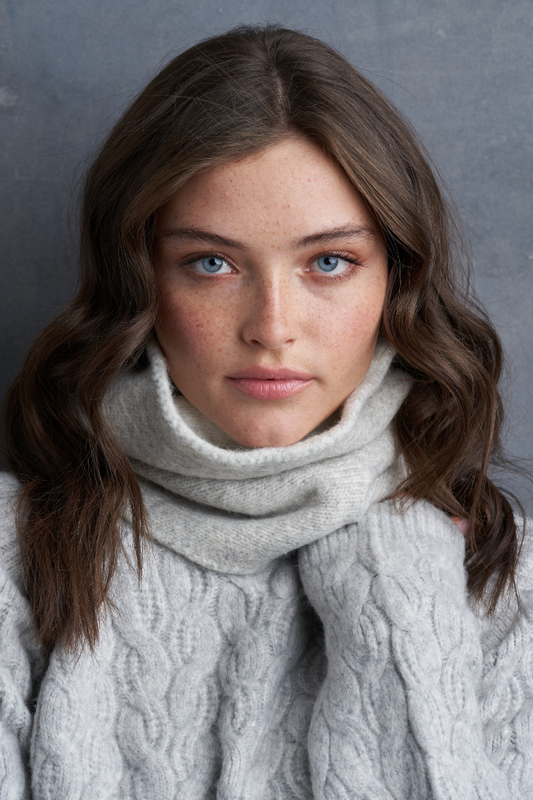Brunette Blue Eye Caucasian Female wearing a Woven Ribbed-knit  Warm  Soft  Casual  Cozy  Stretchy Multipurpose headwear or scarf  Easy Slip-On Snood paired with a ribbed turtleneck sweater