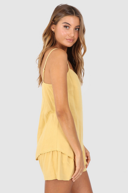 Bailage Haired Caucasian Female wearing Spaghetti Adjustable Straps  Lightweight  Scoop Hemline  Soft Fabric  Casual  Basic  Low-Scoop Neck  Undershirt Camisole Linen-Blend Cami Tank Top in  Honey Yellow 