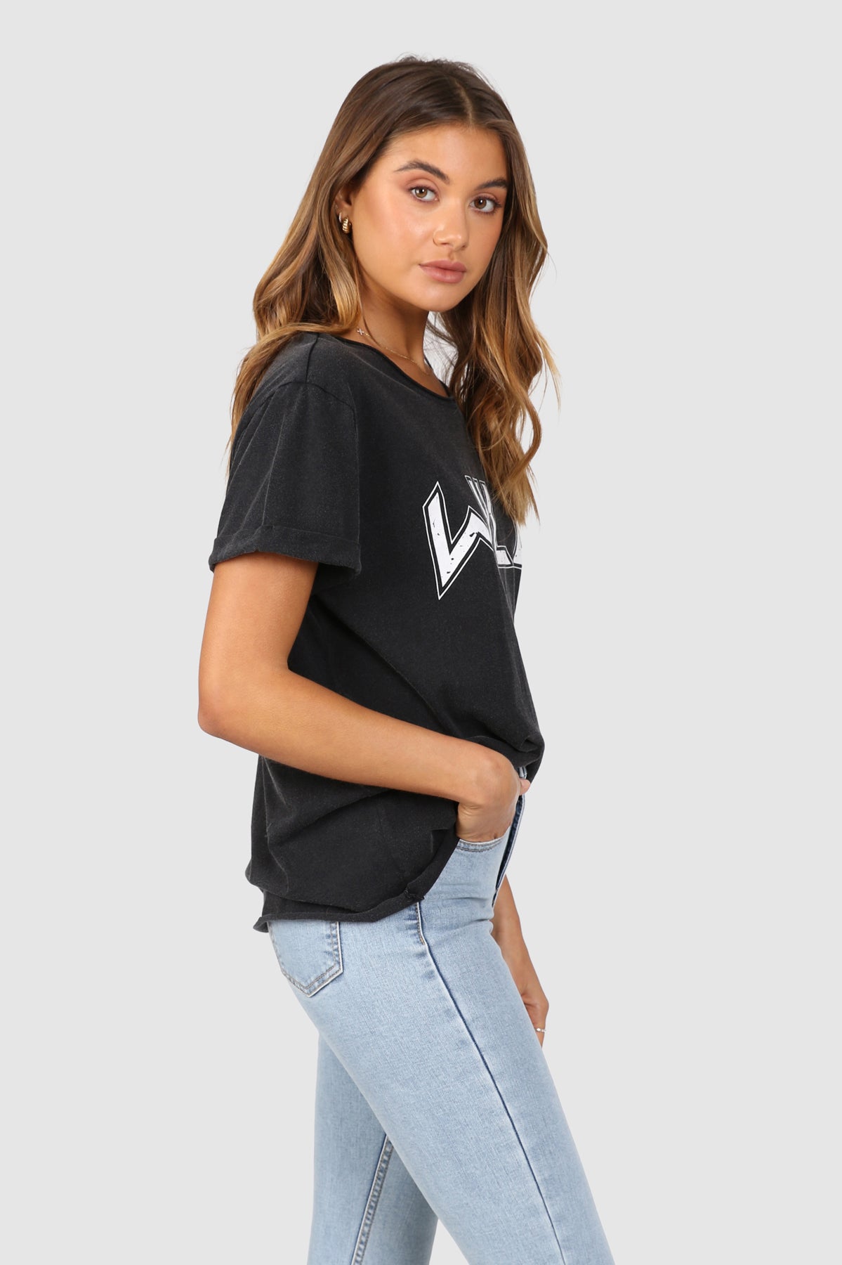 Bailage Caucasian Female wearing Vintage Casual Basic WILD Graphic Tee Short Sleeved T-Shirt Relaxed Fit Round Neck paired with high waisted light washed denim jeans and white sneakers