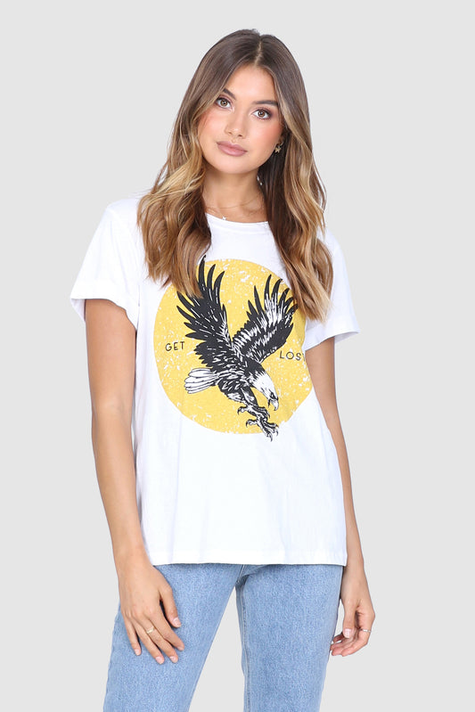 Bailage Haired Caucasian Female wearing aVintage Casual Eagle Graphic Tee Cotton Short Sleeved T-Shirt Relaxed Fit Round Neck Top paired with high waisted light washed mom jeans and white converse