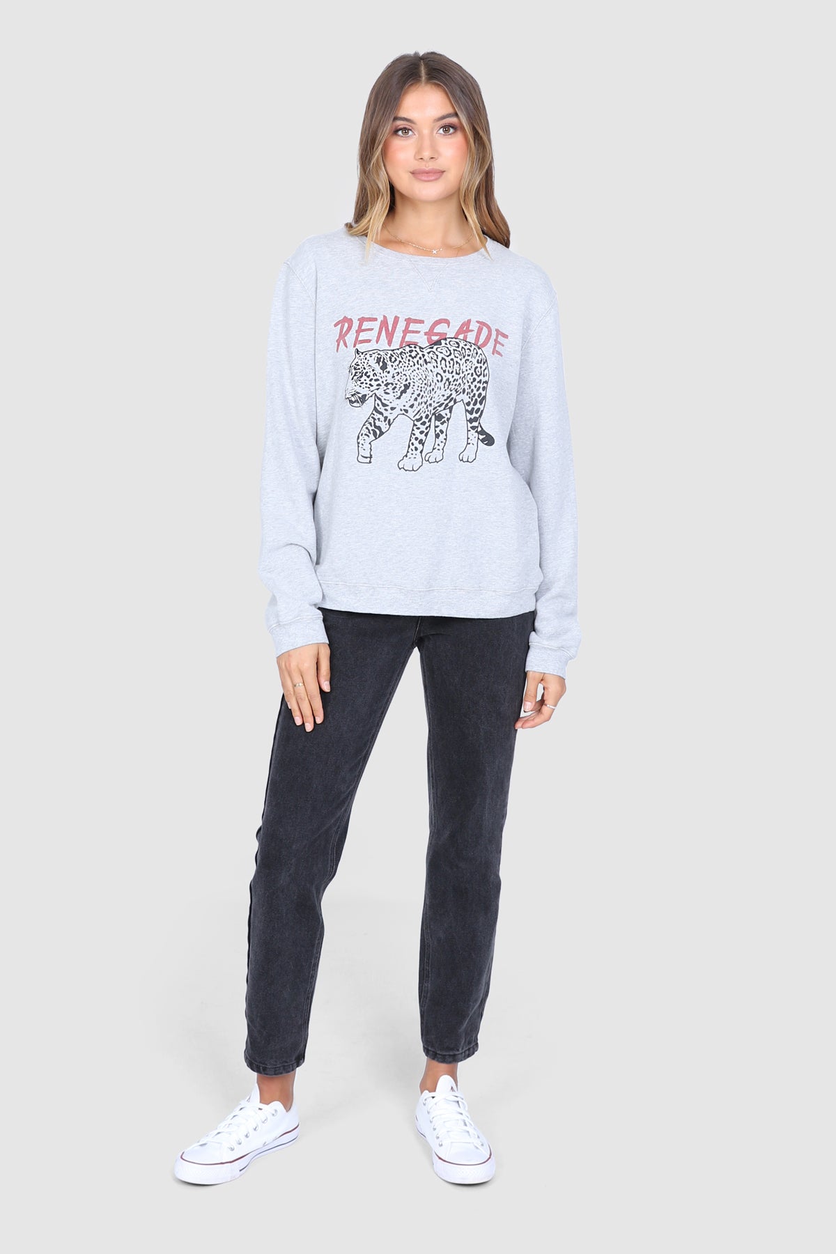 Bailage Haired Caucasian Female wearing a Relaxed Fit  Basic  Casual  Scoop Neck  Leopard Print  Crew neck Jumper  Graphic Designed Sweater  Cuffed Long Sleeves paired with high waisted black denim jeans and white converse