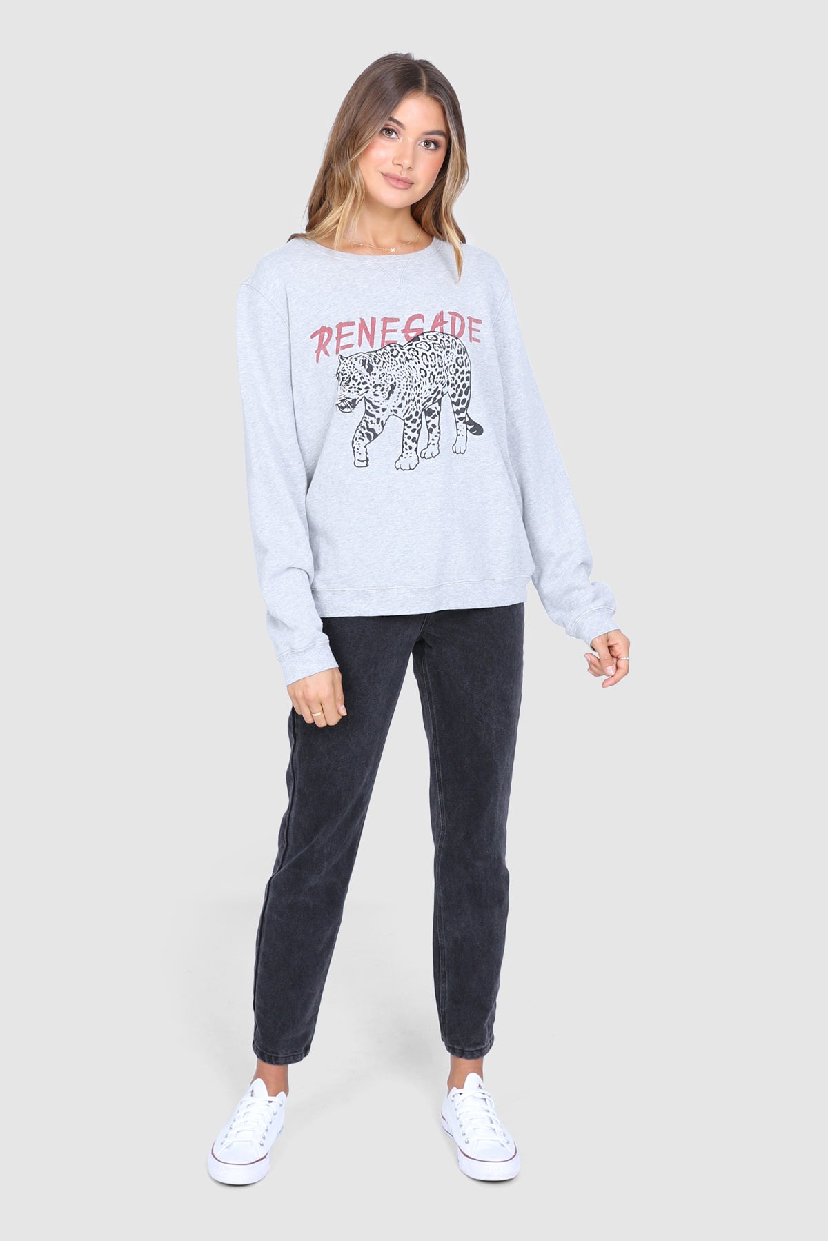 Bailage Haired Caucasian Female wearing a Relaxed Fit  Basic  Casual  Scoop Neck  Leopard Print  Crew neck Jumper  Graphic Designed Sweater  Cuffed Long Sleeves paired with high waisted black denim jeans and white converse