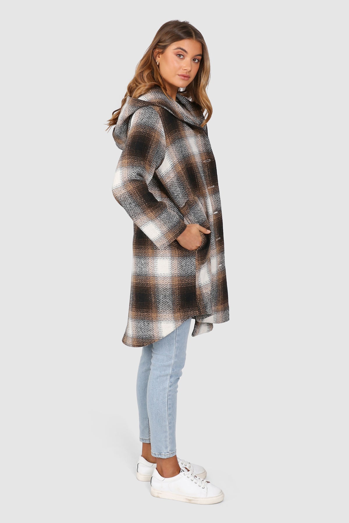 Bailage Haired Caucasian female wearing Plaid Print  Two-oversized front pocket  Relaxed Shoulder  Checkered Lapel Coat  Mid-Length  Buttoned Down  Hooded  Overcoat  Jacket  paired with cotton round neck white tee and high waisted denim jeans and white sneakers 