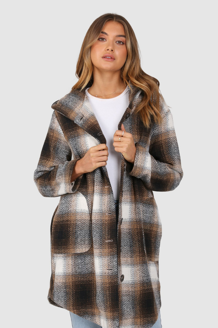 Bailage Haired Caucasian female wearing Plaid Print  Two-oversized front pocket  Relaxed Shoulder  Checkered Lapel Coat  Mid-Length  Buttoned Down  Hooded  Overcoat  Jacket  paired with cotton round neck white tee and high waisted denim jeans