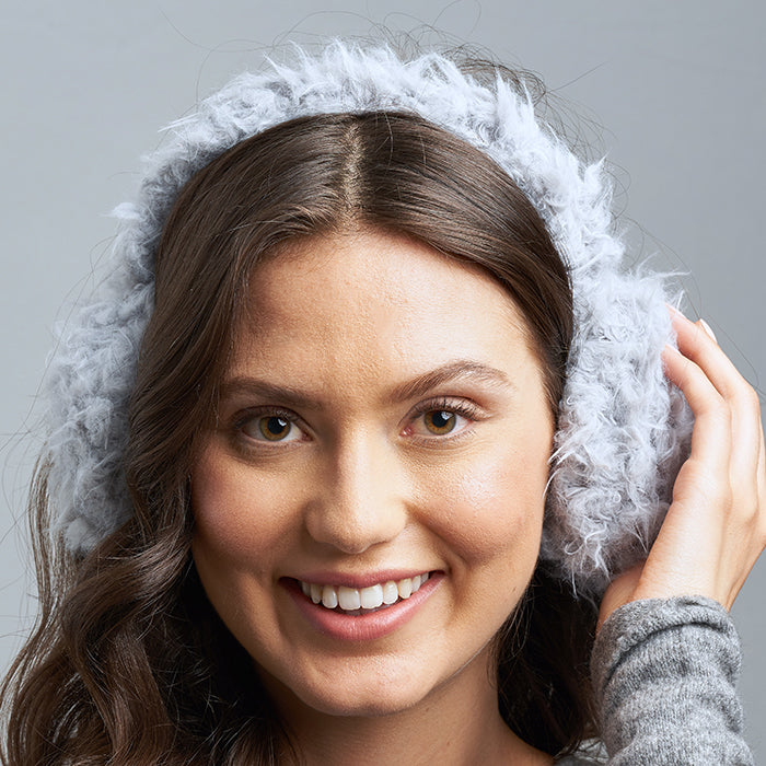 Brunette Caucasian Female Wearing Fluffy  Whimsical  Stretchy Headband  Lightweight  Foldable  Big Ear Warmers  Winter Ear Muffs in Windy